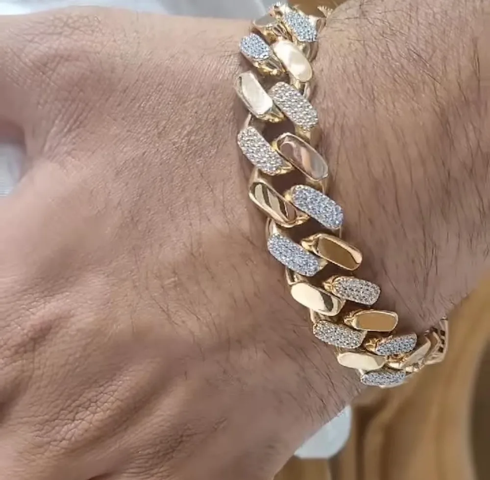 Iced-out gold Cuban link bracelet on a wrist