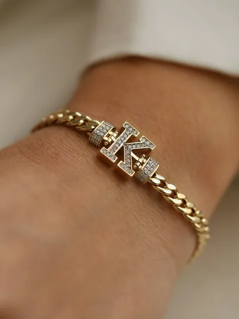 Gold Cuban bracelet with an iced initial charm
