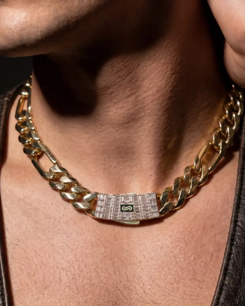 Man wearing a heavy gold Figaro chain with an iced baguette clasp at the collarbone