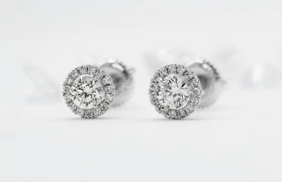Halo stud earrings in white gold on a white background