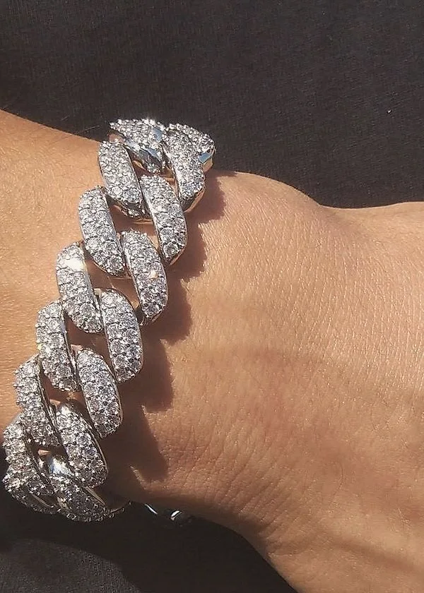 Iced white gold Cuban link bracelet on a wrist