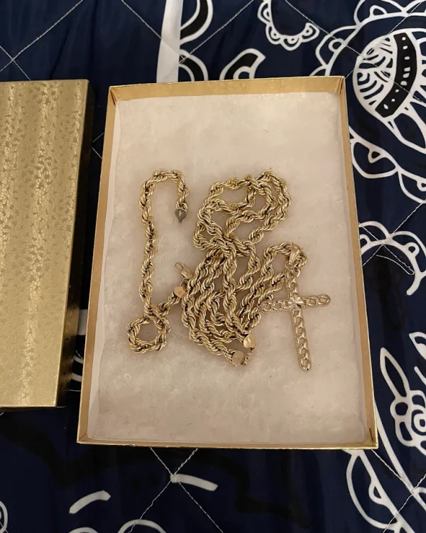 Solid gold rope chain with a gold cross pendant in a gift box