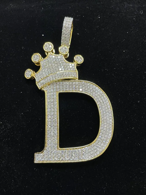 Iced gold letter D pendant topped with a crown
