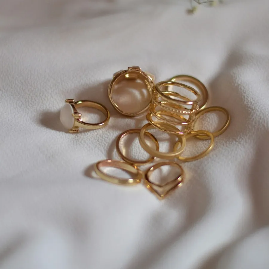 Stack of gold rings on white linen