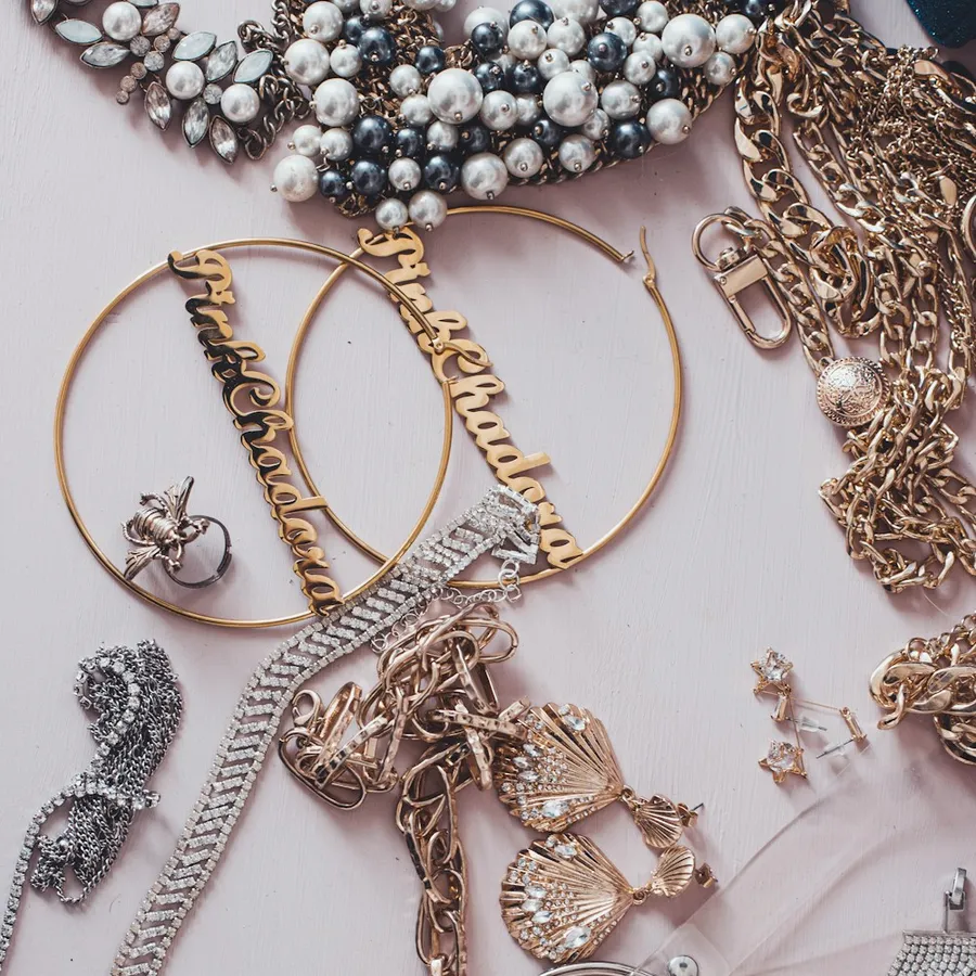 Flat lay of gold and silver chains, rings and earrings